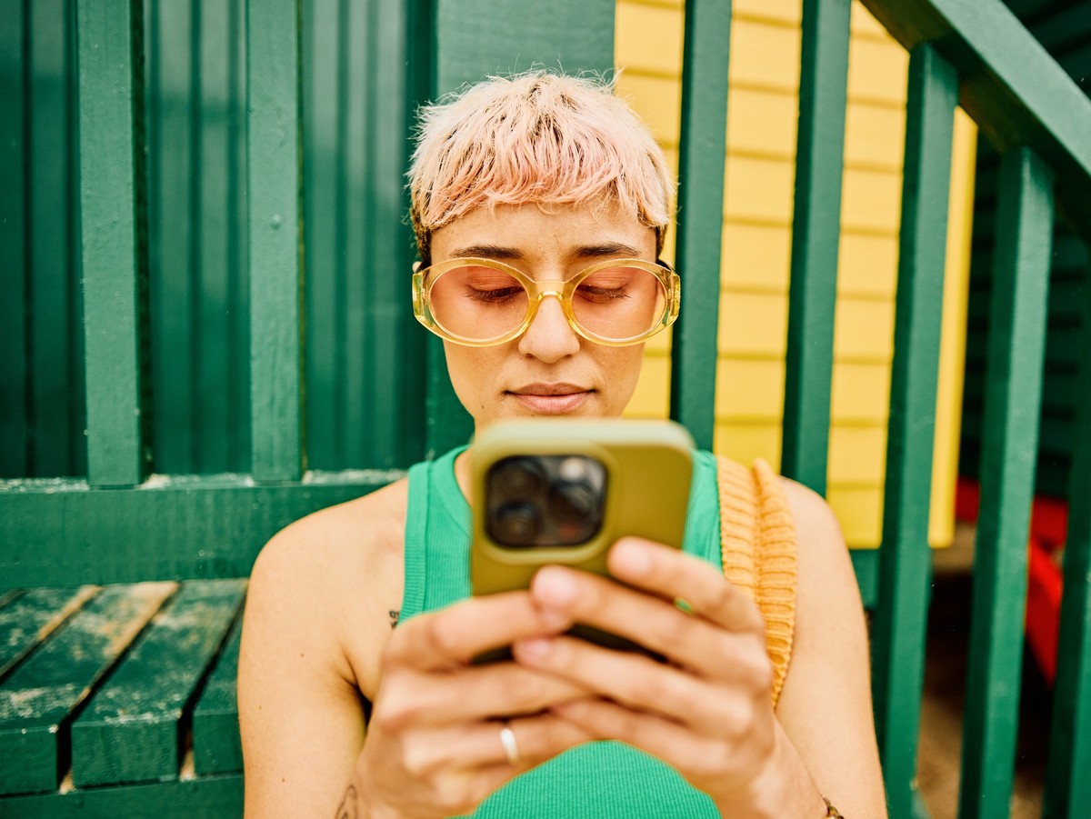 Young solo traveller using her phone on vacation