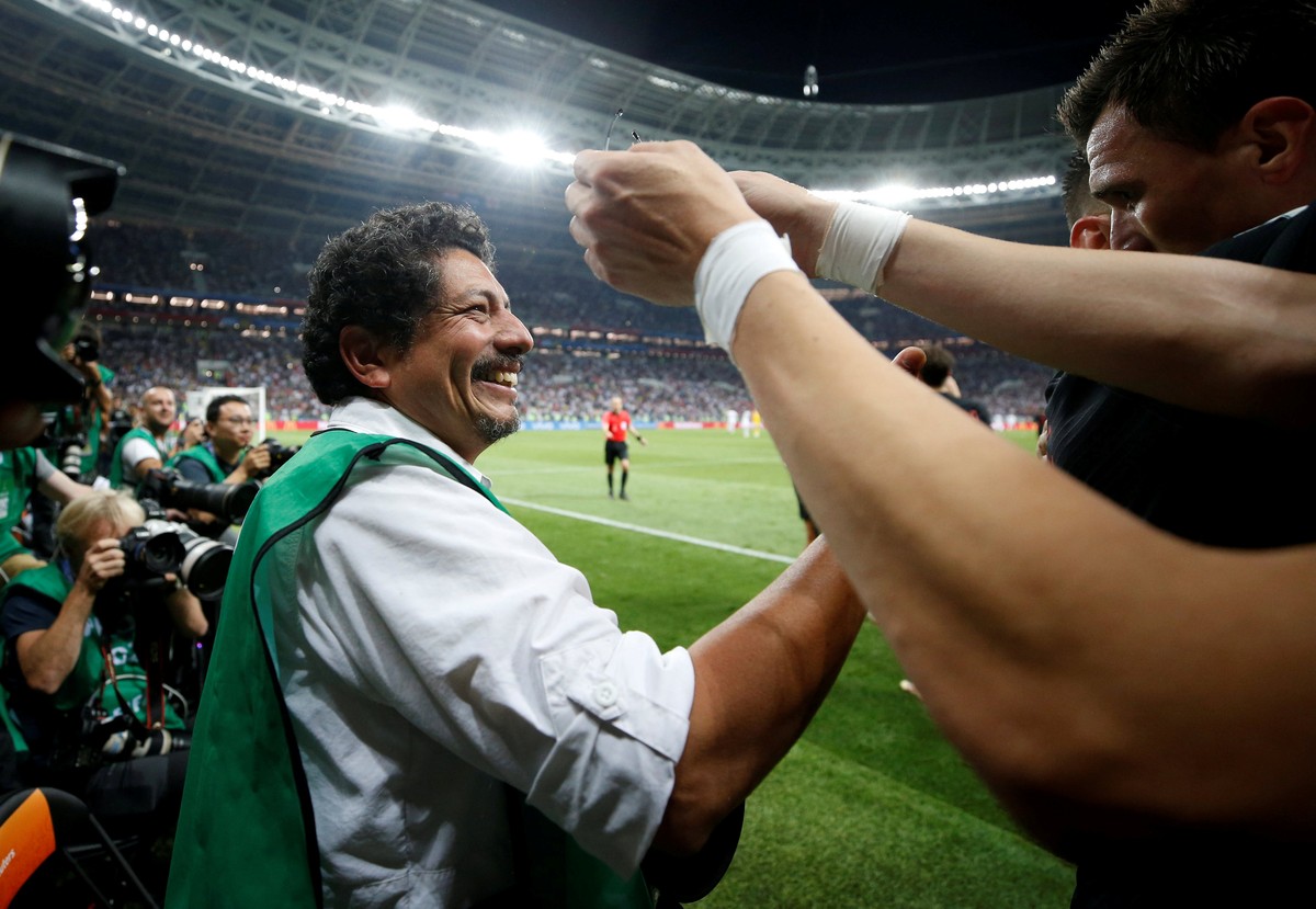 Soccer Football - World Cup - Semi Final - Croatia v England - Luzhniki Stadium, Moscow, Russia - July 11, 2018 Croatia's Mario Mandzukic celebrates next to an AFP photographer Yuri Cortez after ...