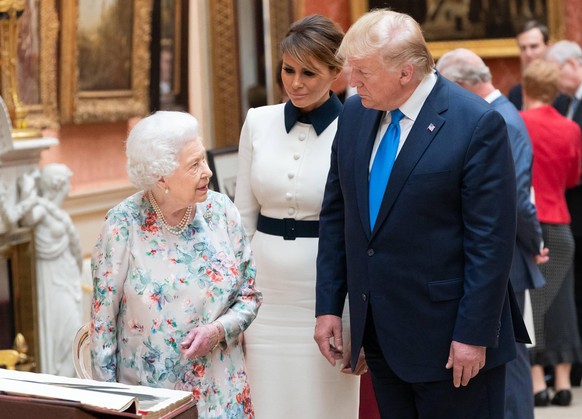 President Donald J. Trump and First Lady Melania Trump review items from the Royal Collection with Britain�s Queen Elizabeth II on June 3, 2019, in the Picture Gallery at Buckingham Palace in London.  ...