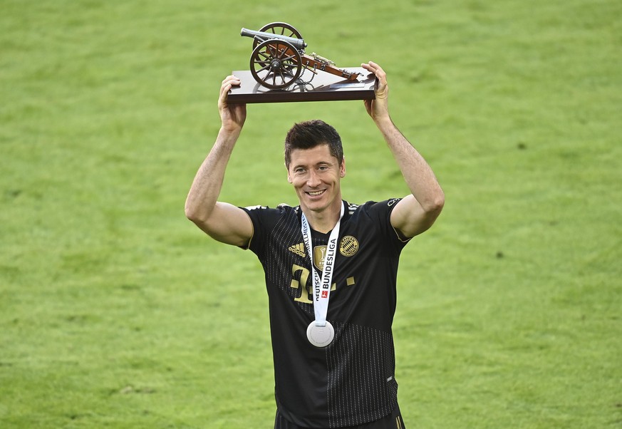 Bayern's Robert Lewandowski holds a trophy of the best scorer of the season after winning the Bundesliga title after the German Bundesliga soccer match between Bayern Munich and FC Augsburg at the All ...