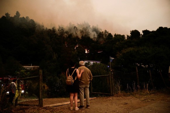 Residents watch during a wildfire in Santa Juana, near Concepcion, Chile, February 3, 2023. REUTERS/Juan Gonzalez