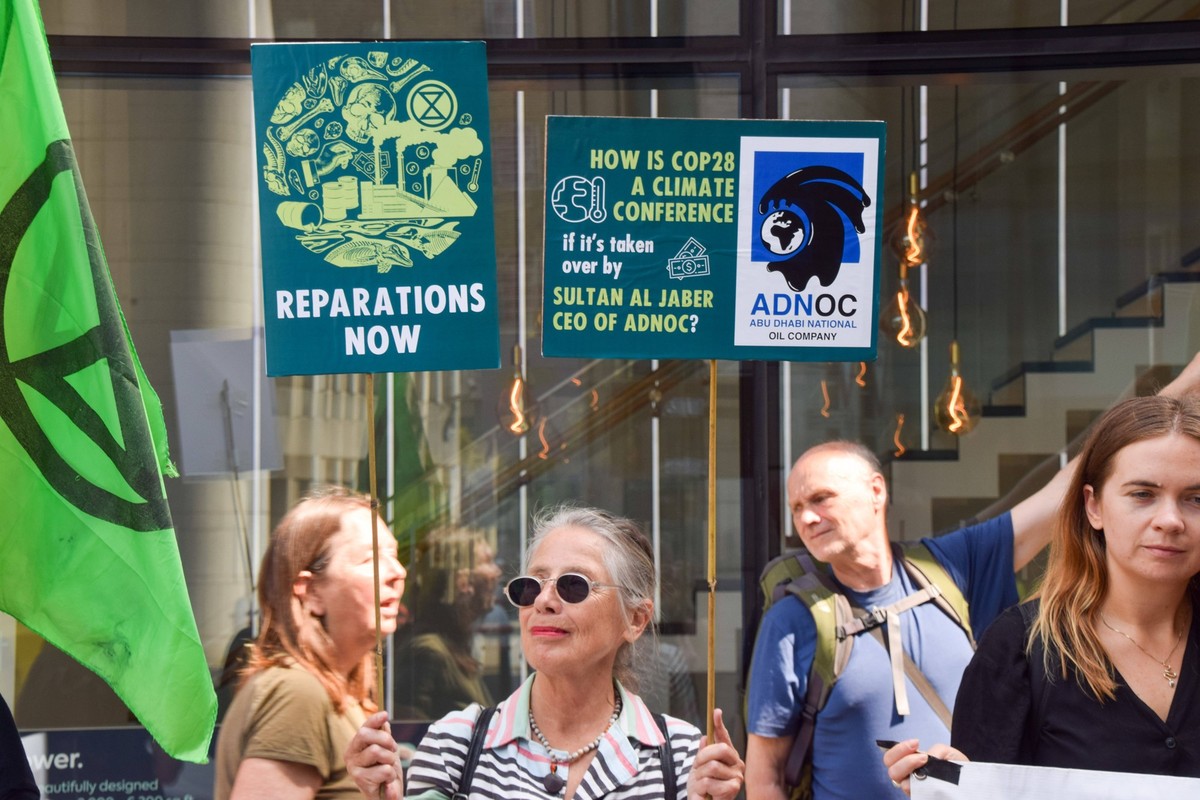 June 12, 2023, London, United Kingdom: A climate activist holds a placard which criticises the election of Sultan Al Jaber, the CEO of the Abu Dhabi National Oil Company ADNOC, as president of COP28,  ...