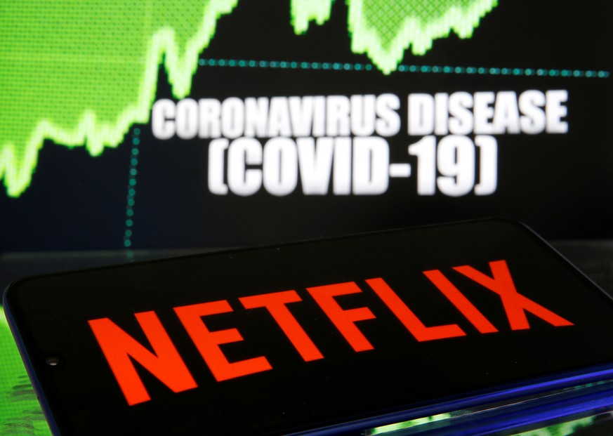 FILE PHOTO: Netflix logo is seen in front of diplayed coronavirus disease (COVID-19) in this illustration taken March 19, 2020. REUTERS/Dado Ruvic/File Photo