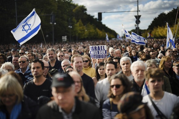 A woman shows a poster reading: &quot;Israel must defend itself&quot; a demonstration against antisemitism and to show solidarity with Israel in Berlin, Germany, Sunday, Oct. 22, 2023. (AP Photo/Marku ...