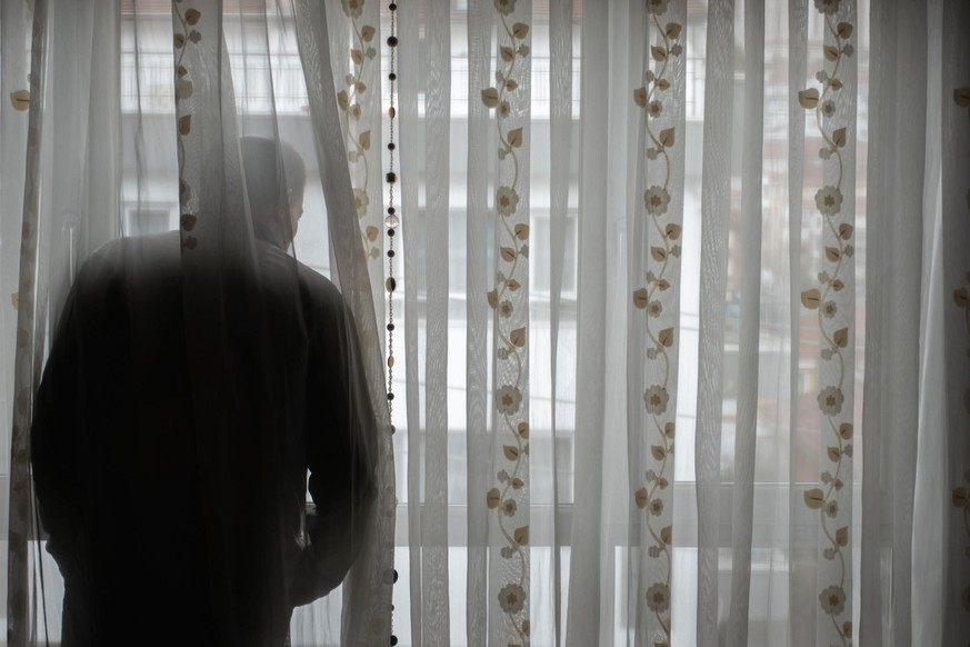 Man looking out of window