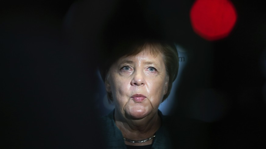 German Chancellor Angela Merkel delivers a statement during a faction meeting of her ruling Christian Union parties faction at the Reichstag building in Berlin, Tuesday, Sept. 25, 2018. (AP Photo/Mark ...