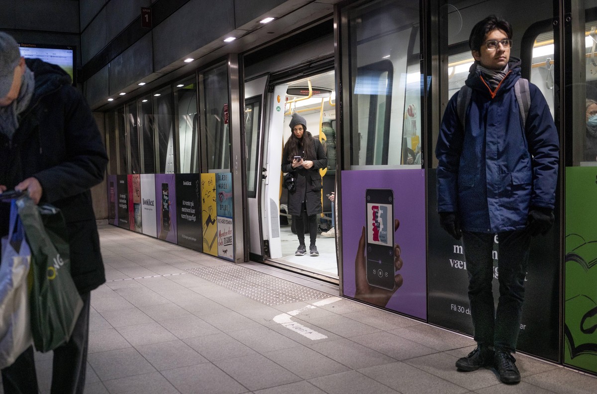 epa09721067 Passengers at Noerreport train station in Copenhagen, Denmark, 01 February 2022. As of today it is no longer mandatory to wear protection mask anywhere in public in Denmark. The Danish Gov ...