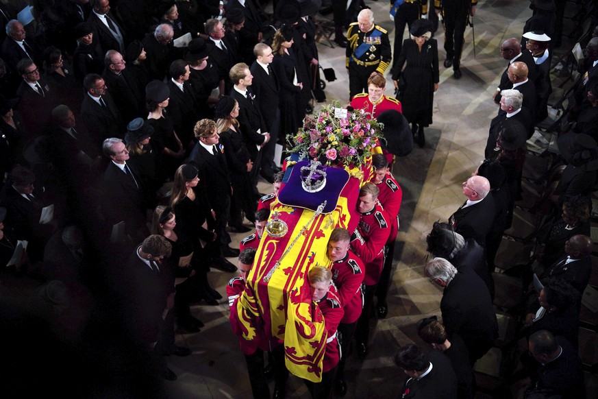 King Charles III and the Queen Consort follow the coffin during the Committal Service for Queen Elizabeth II at St George's Chapel, at Windsor Castle, Windsor, England, Monday Sept. 19, 2022. The Quee ...