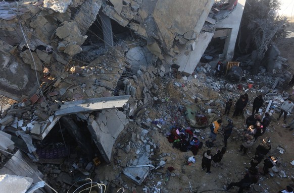240203 -- RAFAH, Feb. 3, 2024 -- Palestinians inspect the debris of a building after Israeli airstrikes in the southern Gaza Strip city of Rafah, Feb. 3, 2024. In the early hours of Saturday, at least ...