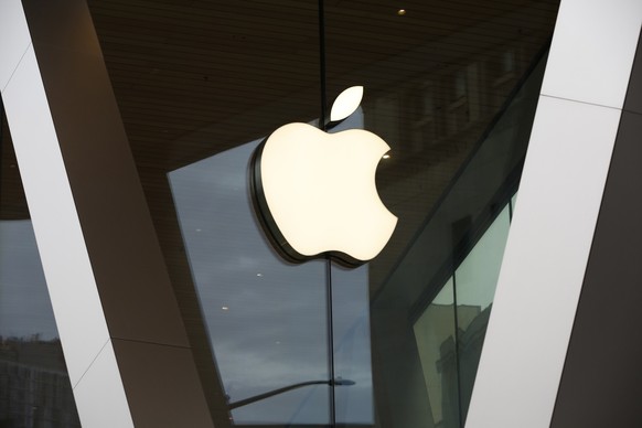 FILE - In this Saturday, March 14, 2020 file photo, an Apple logo adorns the facade of the downtown Brooklyn Apple store in New York. Workers at an Apple store in Oklahoma City voted to unionize, mark ...