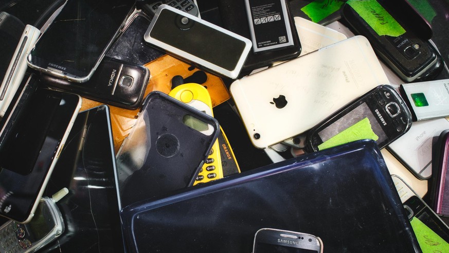 Mosta / Malta - May 11, 2019: Broken mobile digital devices in a bin to be recycled