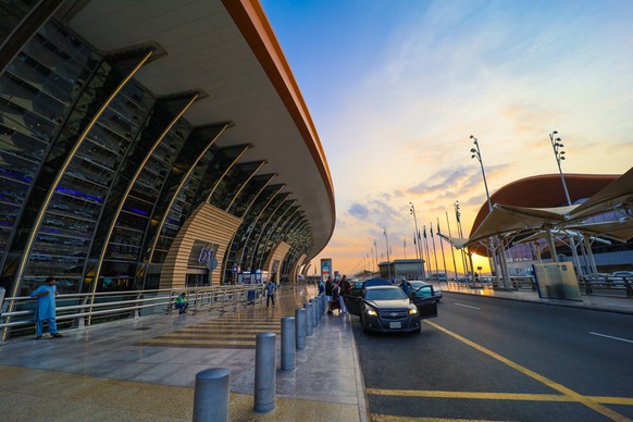 Jeddah , Saudi Arabia - Mar 11 2023 : Passengers traveling through King Abdulaziz International Airport - flight and booking concept