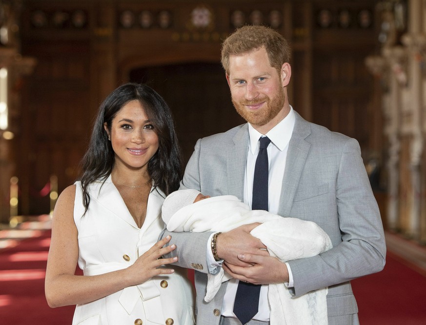 Britain&#039;s Prince Harry and Meghan, Duchess of Sussex, during a photocall with their newborn son, in St George&#039;s Hall at Windsor Castle, Windsor, south England, Wednesday May 8, 2019. Baby Su ...