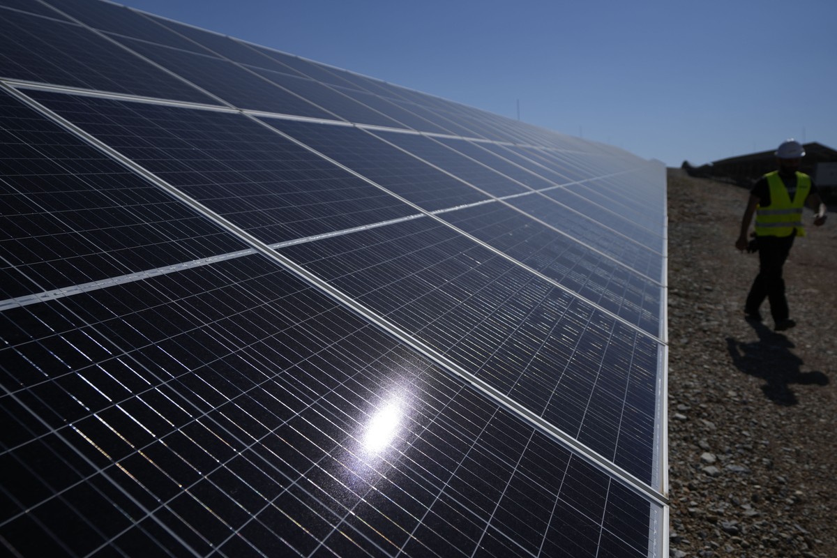 A maintenance engineer walks at a new solar park outside the northern Greek city of Kozani on Friday, June 3, 2022. The newly-completed solar park, one of Europe's largest, is just a half-hour dr ...