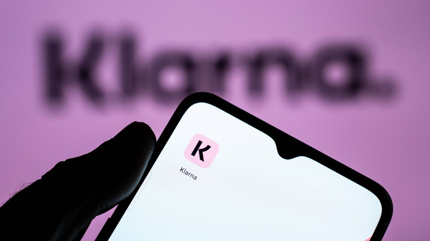 Fintech And Neobanks Stock Photos A person is holding a mobile phone with the Klarna application in front of a screen displaying the Klarna logo. Athens Greece PUBLICATIONxNOTxINxFRA Copyright: xNikos ...