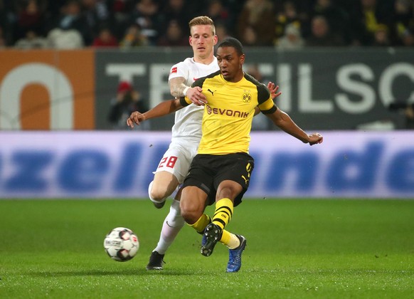 Soccer Football - Bundesliga - FC Augsburg v Borussia Dortmund - WWK Arena, Augsburg, Germany - March 1, 2019 Borussia Dortmund&#039;s Abdou Diallo in action with Augsburg&#039;s Andre Hahn REUTERS/Mi ...