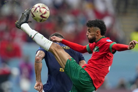 Morocco&#039;s Noussair Mazraoui connects a shot during the World Cup semifinal soccer match between France and Morocco at the Al Bayt Stadium in Al Khor, Qatar, Wednesday, Dec. 14, 2022. (AP Photo/Na ...