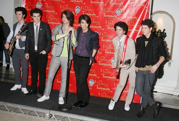 Feb 12, 2009 - New York, New York, USA - (L-R) KEVIN JONAS, JOE JONAS and NICK JONAS, from the Jonas Brothers , stand next to their wax figure at the unveiling held at Madame Tussauds - Times Square.  ...