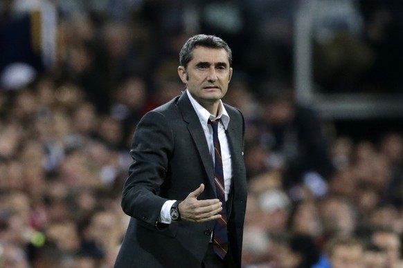 Barcelona coach Ernesto Valverde gives instructions to his players during the Spanish La Liga soccer match between Real Madrid and FC Barcelona at the Bernabeu stadium in Madrid, Saturday, March 2, 20 ...