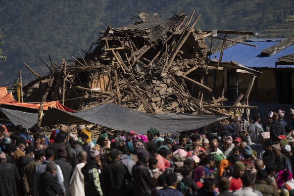 Survivors gather next to damaged houses for the funeral of family members killed in earthquake in Jajarkot district, northwestern Nepal, Sunday, Nov. 5, 2023. Friday night’s earthquake in the district ...