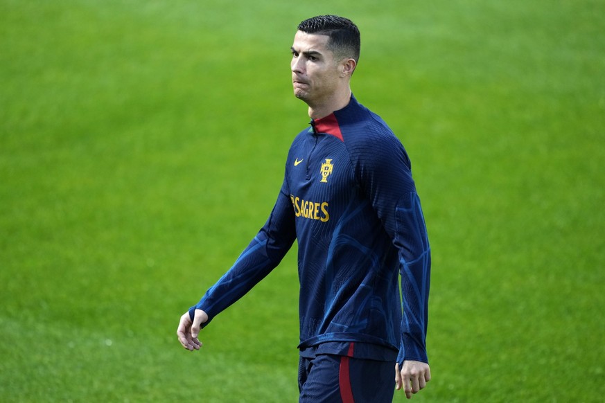 Cristiano Ronaldo walks on the pitch during a Portugal soccer team training in Oeiras, outside Lisbon, Monday, Nov. 14, 2022. Portugal will play Nigeria Thursday in a friendly match in Lisbon before d ...
