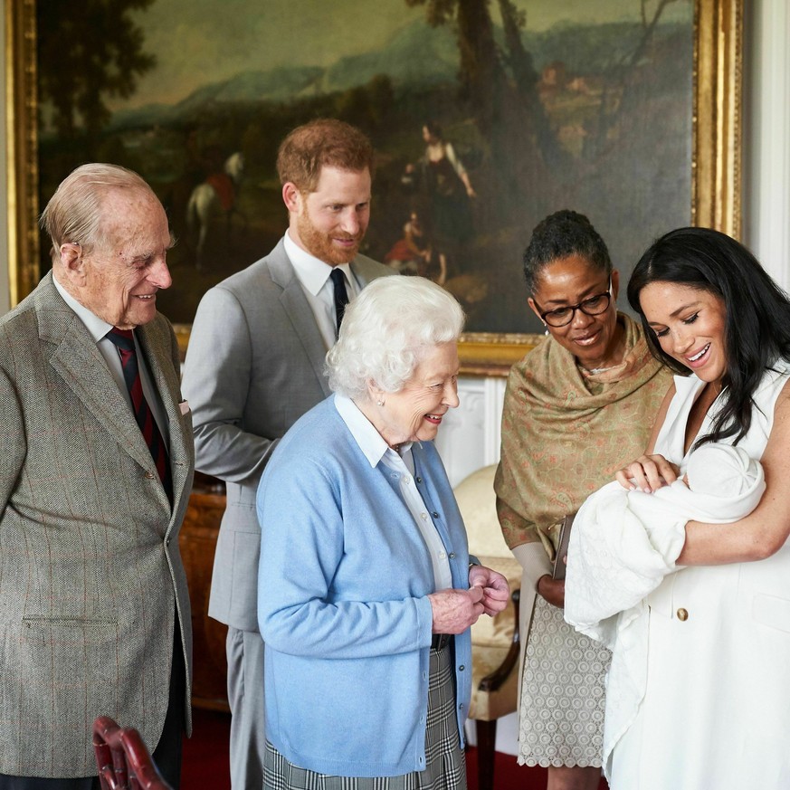 In this image made available by SussexRoyal on Wednesday May 8, 2019, Britain's Prince Harry and Meghan, Duchess of Sussex, joined by her mother Doria Ragland, show their new son to Queen Elizabeth II ...