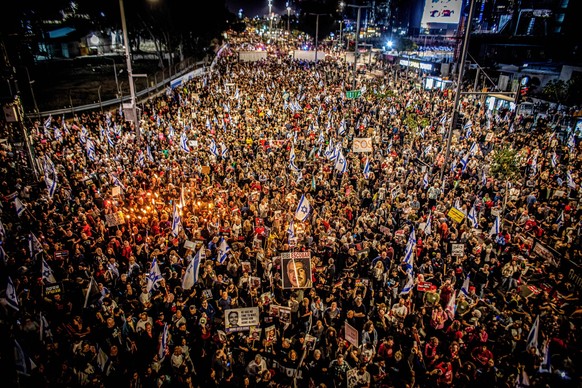 March 30, 2024, Tel Aviv, Israel: Protestors hold torches during a protest rally in Tel Aviv Saturday, March 30 2024. On Saturday, tens of thousands took to the across Israel in the largest protest si ...