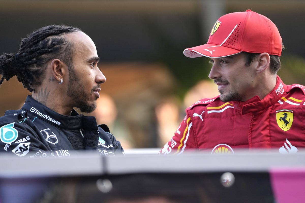 Ferrari driver Charles Leclerc of Monaco, right, speaks with Mercedes driver Lewis Hamilton of Britain as they arrive for the Formula One Bahrain Grand Prix at the Bahrain International Circuit in Sak ...