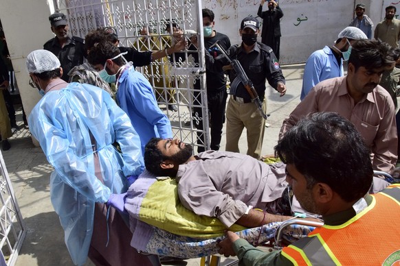 Paramedics and volunteers transport an injured victim of a bomb explosion upon arrival at a hospital, in Quetta, Pakistan, Friday, Sept. 29, 2023. A powerful bomb exploded at a rally celebrating the b ...