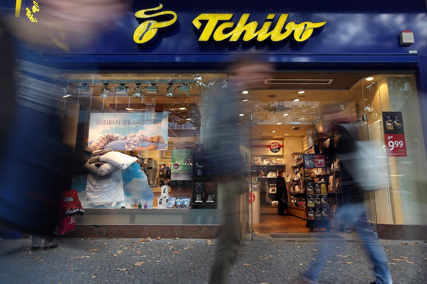 BERLIN, GERMANY - OCTOBER 20: Shoppers pass a Tchibo store on October 20, 2012 in Berlin, Germany. Retail business is the third-biggest economic sector in Germany, and consumer spending has held up we ...