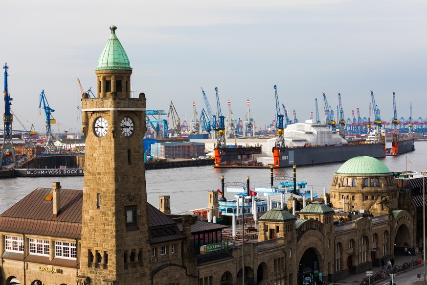 Jetties St. Pauli-Landungsbrucken, Hamburg, Germany. .Two towers with green domes mark the 205 meter long passenger terminal at the jetties. One of the towers does not only inform of the current time, ...