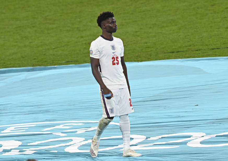 England's Bukayo Saka walks away after getting his medal during the trophy ceremony after Italy won the Euro 2020 final soccer match between Italy and England at Wembley stadium in London, Sunday, Jul ...