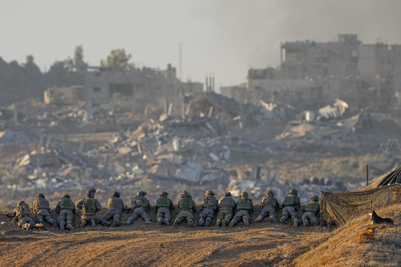 Israeli soldiers take positions near the Gaza Strip border, in southern Israel, Monday, Dec. 11, 2023. The army is battling Palestinian militants across Gaza in the war ignited by Hamas&#039; Oct. 7 a ...