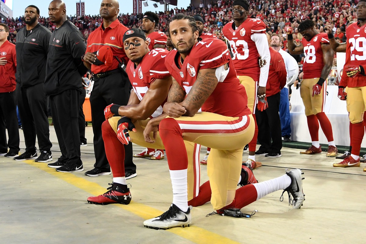 SANTA CLARA, CA - SEPTEMBER 12: Colin Kaepernick #7 and Eric Reid #35 of the San Francisco 49ers kneel in protest during the national anthem prior to playing the Los Angeles Rams in their NFL game at ...