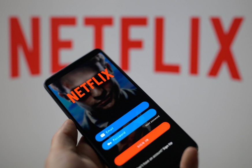 Netflix - Photo Illustration The Netflix app login is being displayed on a smartphone with Netflix visible in the background in this photo illustration taken in Brussels, Belgium, on May 5, 2024. Brus ...
