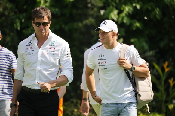 Mercedes team boss Toto Wolff, left, and reserve driver Mick Schumacher arrives before the first practices during the Singapore Formula One Grand Prix at the Marina Bay circuit in Singapore, Friday, S ...