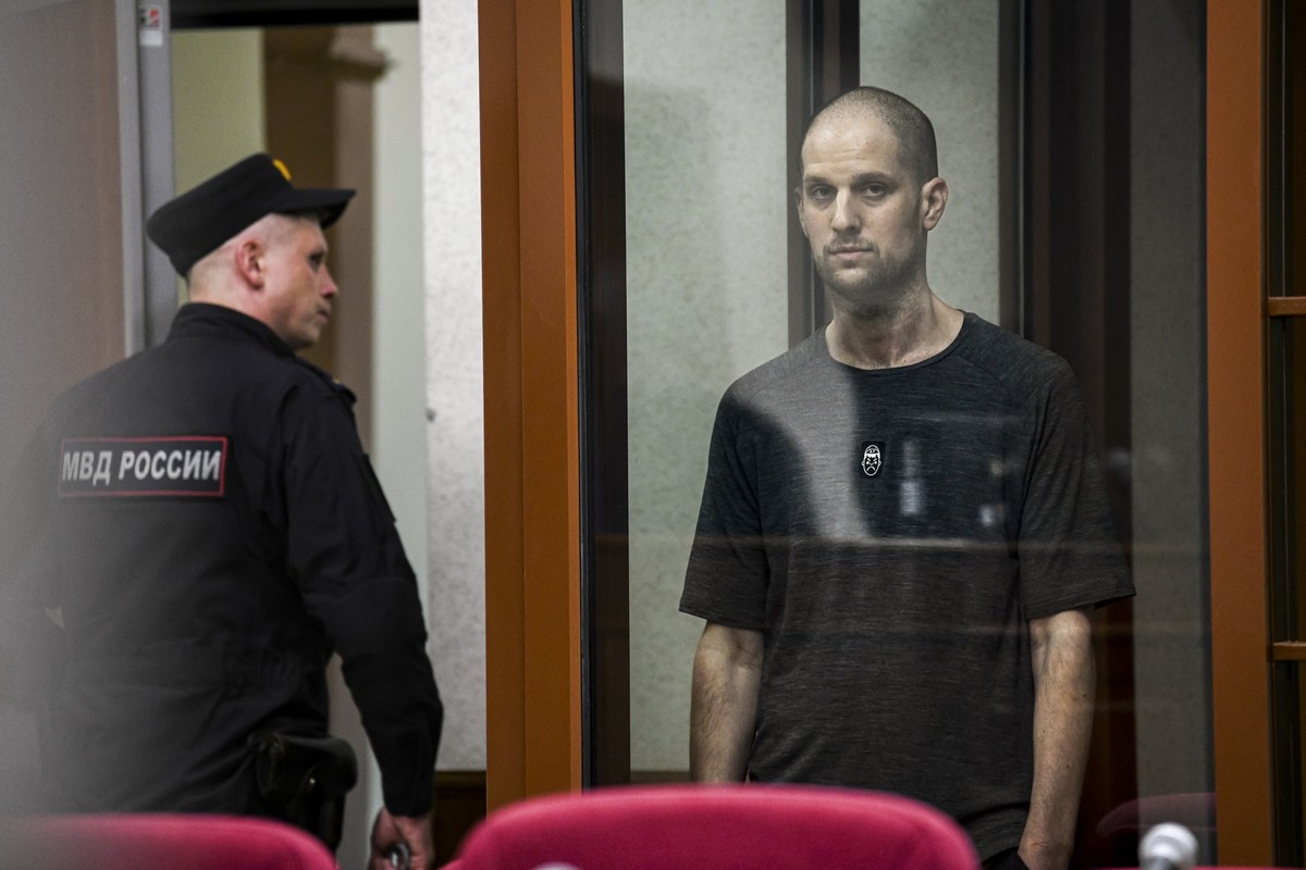 Wall Street Journal reporter Evan Gershkovich stands listening to the verdict in a glass cage of a courtroom inside the building of &quot;Palace of justice,&quot; in Yekaterinburg, Russia, on Friday,  ...