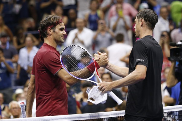 Roger Federer, of Switzerland, left, shakes hands with John Millman, of Australia, after losing during the fourth round of the U.S. Open tennis tournament early Tuesday, Sept. 4, 2018, in New York. (A ...