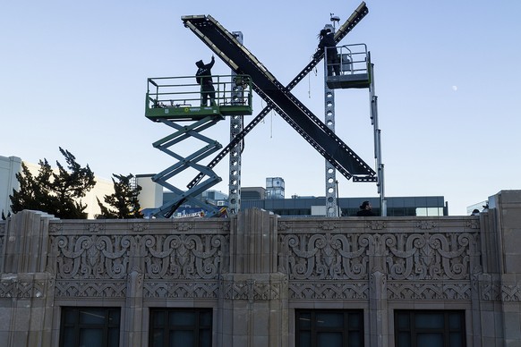 Workers install lighting on an &quot;X&quot; sign atop the downtown San Francisco building that housed what was formally known as Twitter, now rebranded X by owner Elon Musk, Friday, July 28, 2023. (A ...