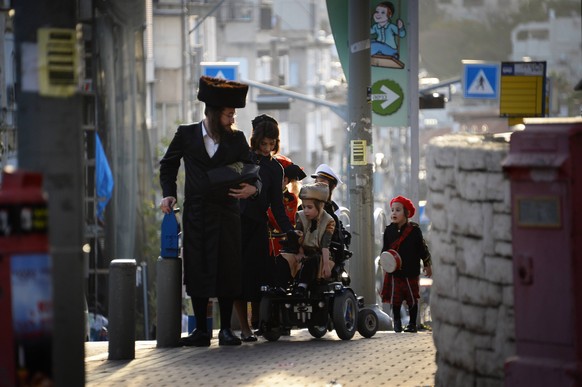 BNEI BRAK, ISRAEL - MARCH 1, 2018: Celebrations of the Jewish holiday of Purim. The holiday commemorates the time when the Jewish people were saved from extermination under Artaxerxes I of Persia in t ...