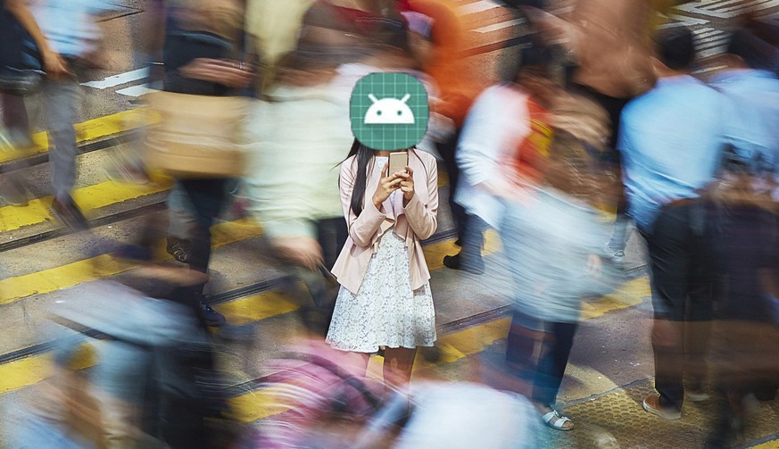 High angle view of young professional using mobile phone amidst crowd. Businesswoman is standing on busy street. She is surrounded by people in city.