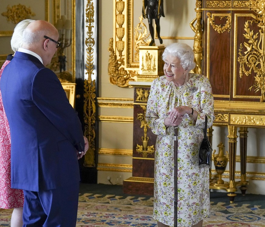 Queen Elizabeth II. Embargoed to 2230 Thursday March 24 Queen Elizabeth II meets Pamela Harper (hidden) and Dr Peter Harper from British craftwork company, Halcyon Days as she views a display of artef ...