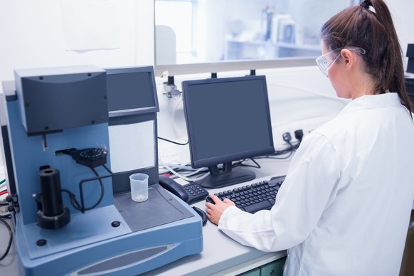 Young scientist typing on his computer in laboratory