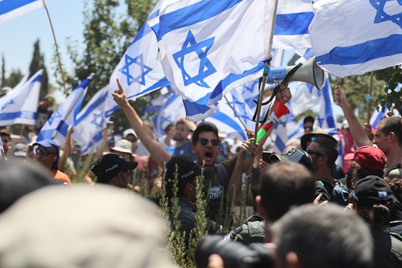 24.07.2023, Israel, Jerusalem: Demonstranten stehen in der N�he der Stra�e, die zur Knesset f�hrt. An diesem Montag (24.07.2023) k�nnte Israels Parlament �ber ein Kernelement der umstrittenen Regierun ...