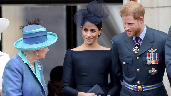 LONDON, ENGLAND - JULY 10: (L-R) Queen Elizabeth II, Meghan, Duchess of Sussex and Prince Harry, Duke of Sussex watch the RAF flypast on the balcony of Buckingham Palace, as members of the Royal Famil ...