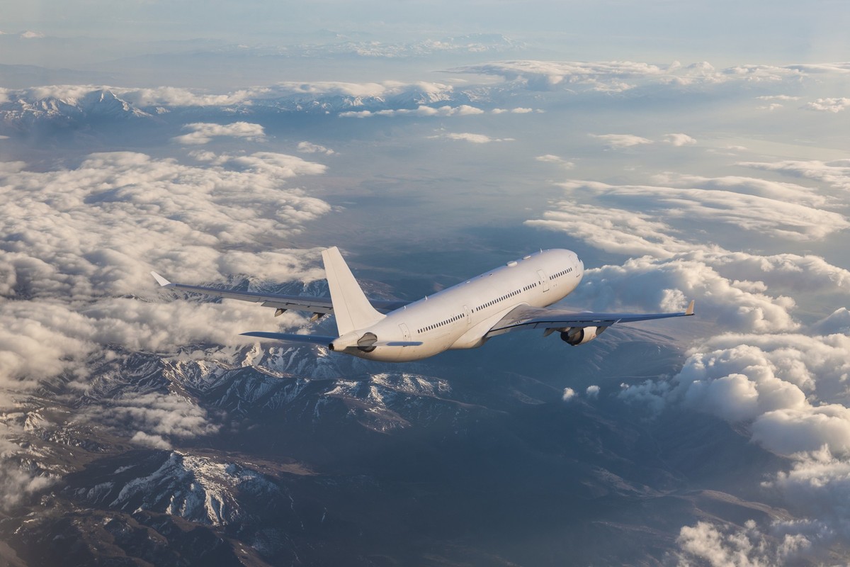 Commercial jet flying over clouds