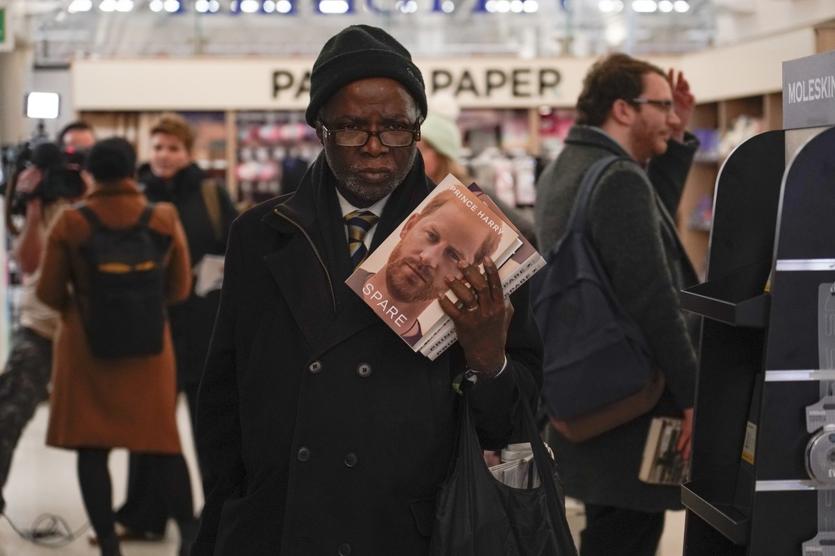 A customer holds copies of the new book by Prince Harry called &quot;Spare&quot; at a book store during a midnight opening in London, Tuesday, Jan. 10, 2023. Prince Harry&#039;s memoir “Spare” arrives ...