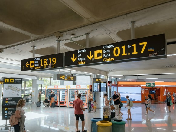 Palma de Mallorca - Jun 22, 2023: Inside an airport terminal, a diverse group navigates the bustling space. Signage guides travel. Model Released Property Released xkwx airport terminal group of peopl ...