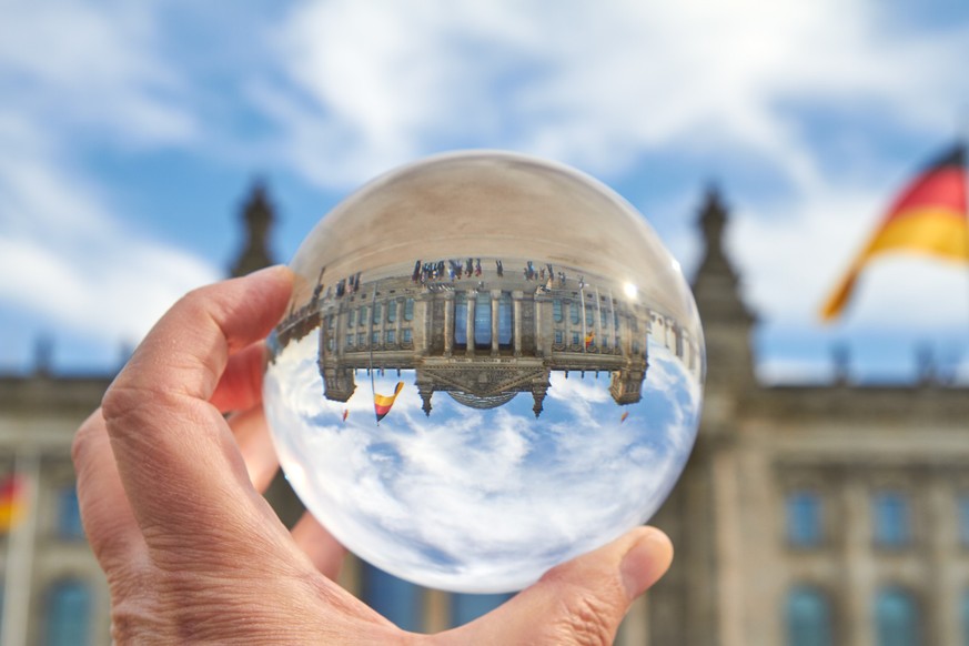 The Reichstag building in Berlin viewed through a glass ball.