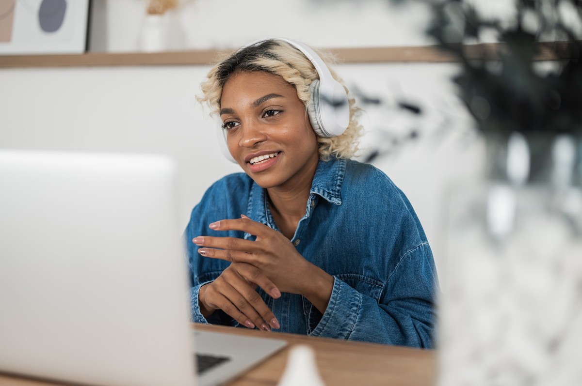 african american woman wear headphones video calling on laptop.teacher ot tutor holding online lesson. Adult person having online job interview xkwx woman videocall business job interview training web ...